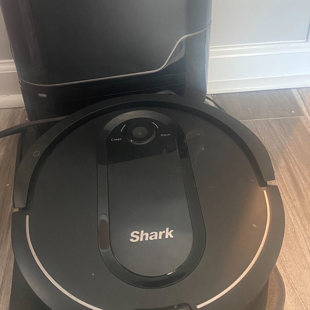 Shark robot iq robot vacuum with self emptying container.